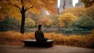 a tranquil corner in central park where a person is meditating on a bench amidst the autumn foliage, finding peace in the bustling city.